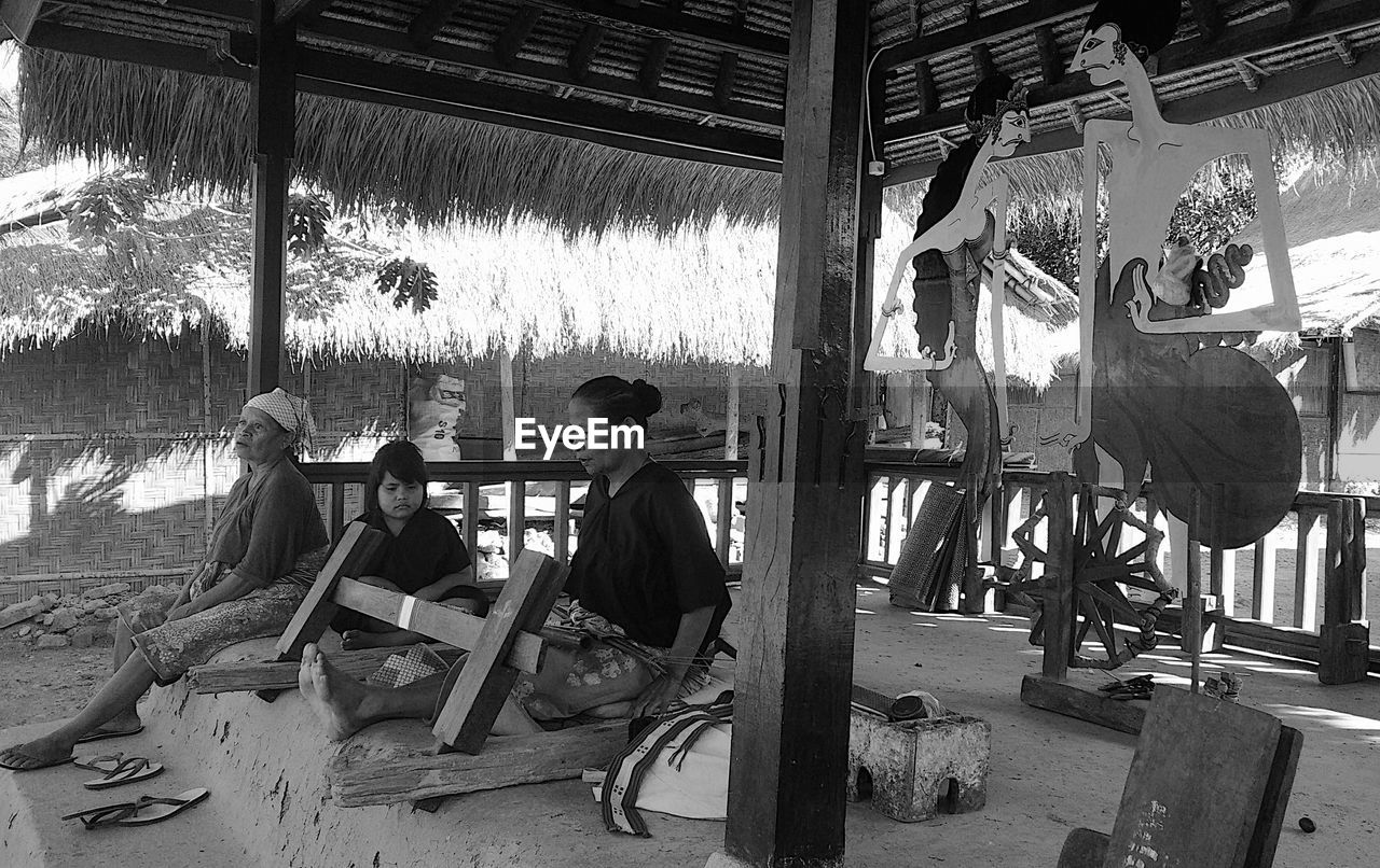 GROUP OF PEOPLE SITTING IN SHOPPING MALL