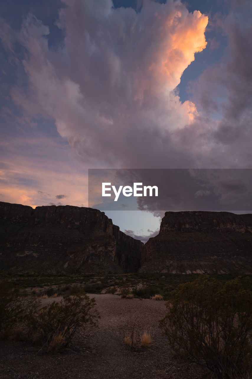 SCENIC VIEW OF ROCK FORMATIONS AGAINST SKY DURING SUNSET