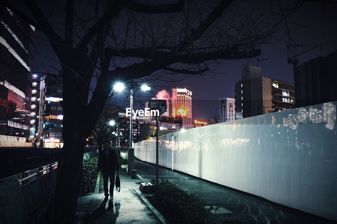 ILLUMINATED CITY AGAINST SKY