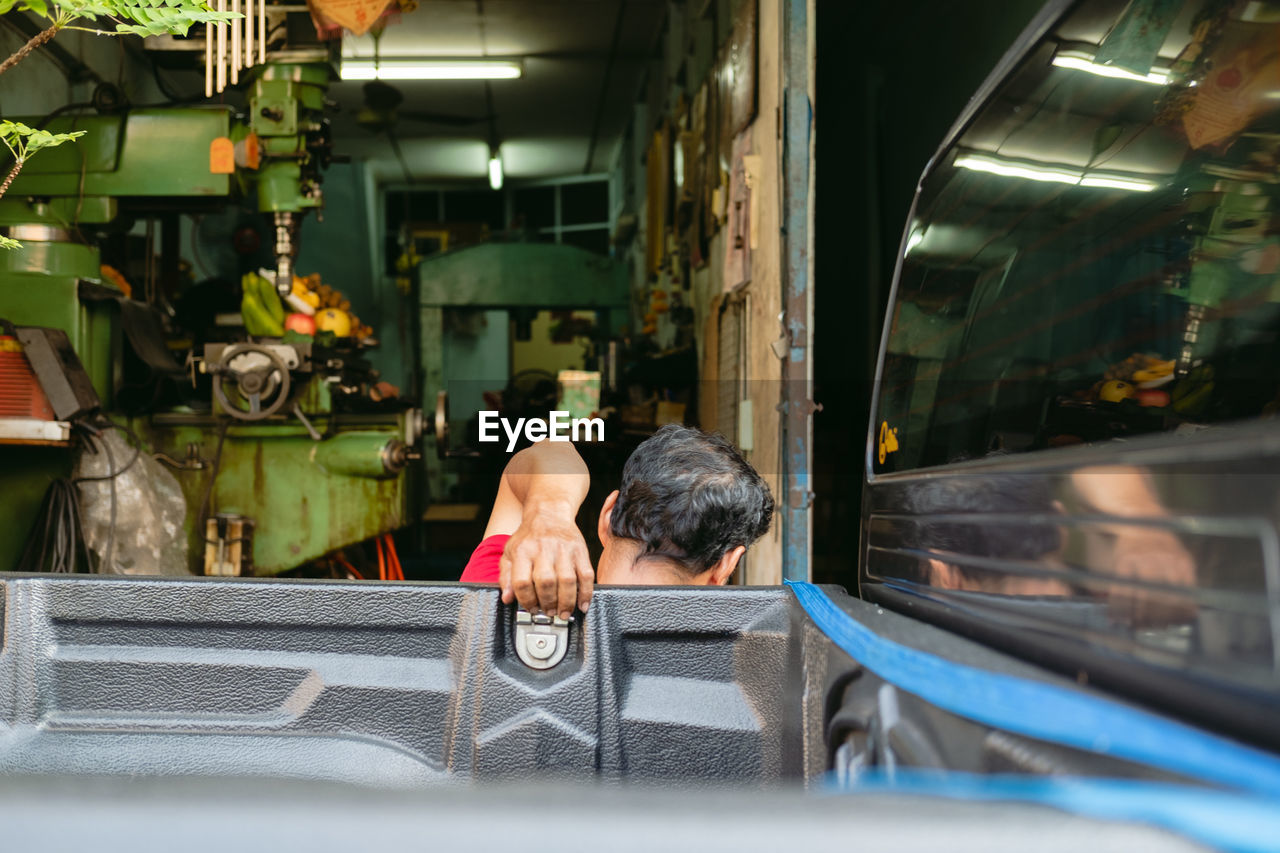 REAR VIEW OF MAN IN CAR