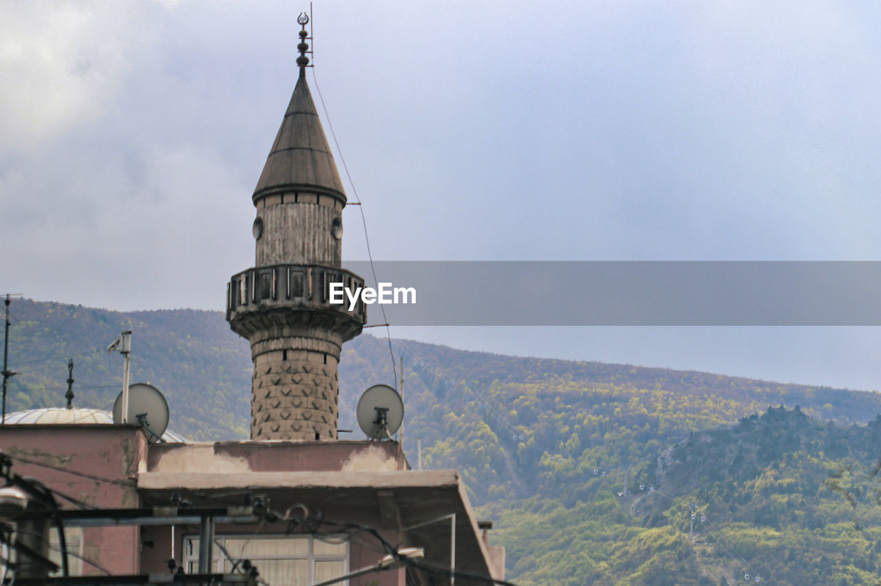 architecture, built structure, building exterior, religion, building, travel destinations, landmark, sky, place of worship, nature, tower, belief, mountain, spirituality, travel, history, no people, day, the past, tourism, outdoors, cloud, dome, city, steeple