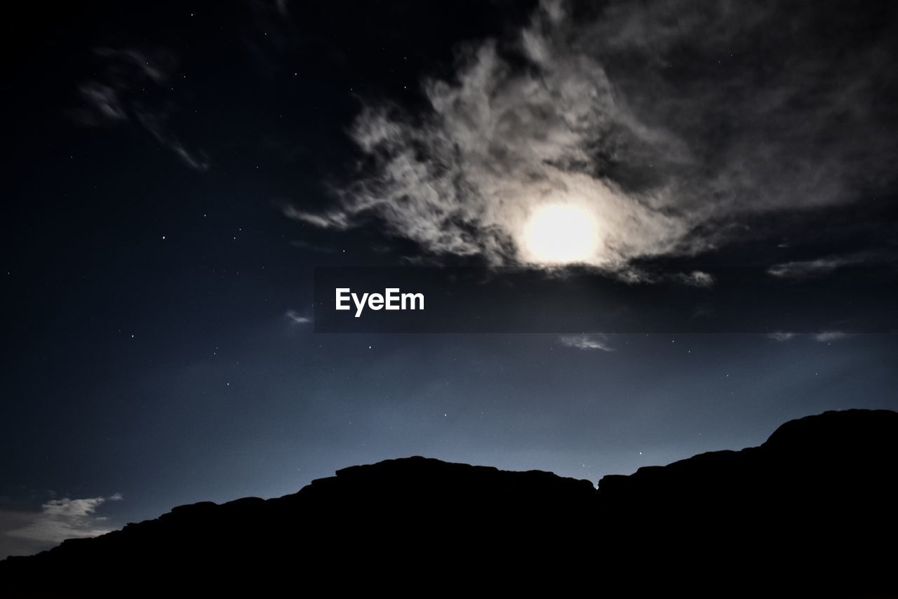 LOW ANGLE VIEW OF SILHOUETTE MOUNTAINS AGAINST SKY