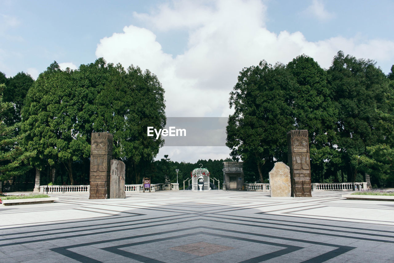 tree, plant, sky, architecture, cloud, nature, town square, the past, history, memorial, travel destinations, city, built structure, no people, day, symbol, outdoors, travel, road, religion, street, landmark, tourism