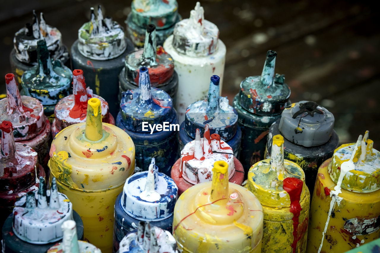High angle view of paint bottles