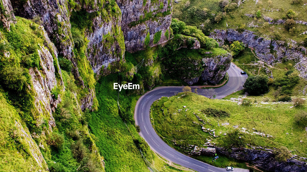 High angle view of winding road amidst plants