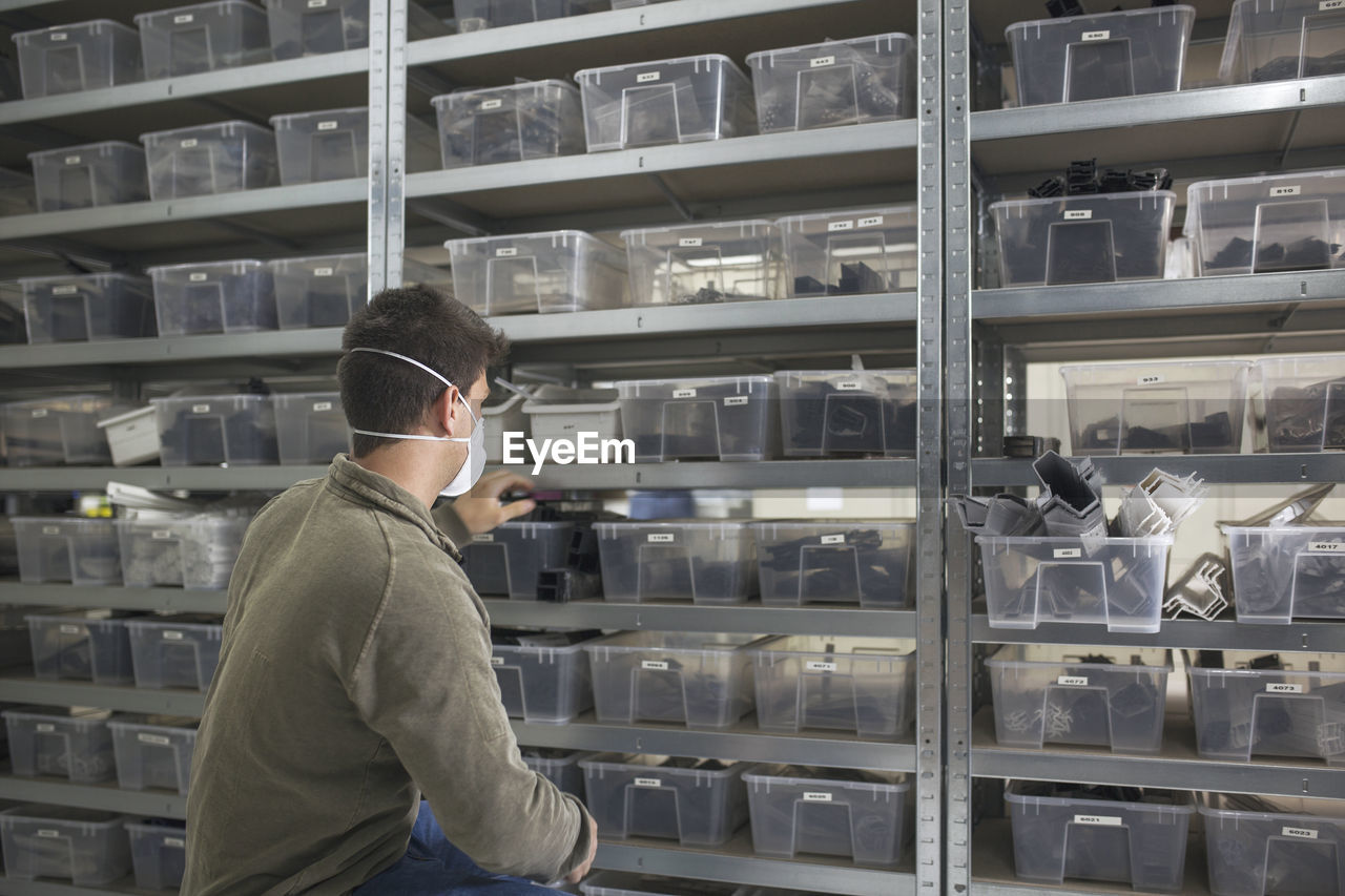 Side view of man working at store