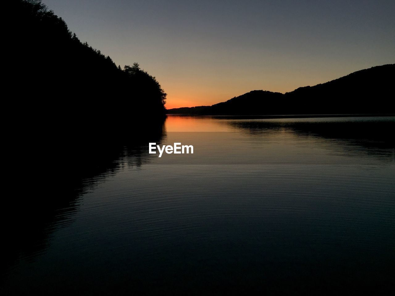 Scenic view of lake against sky during sunset