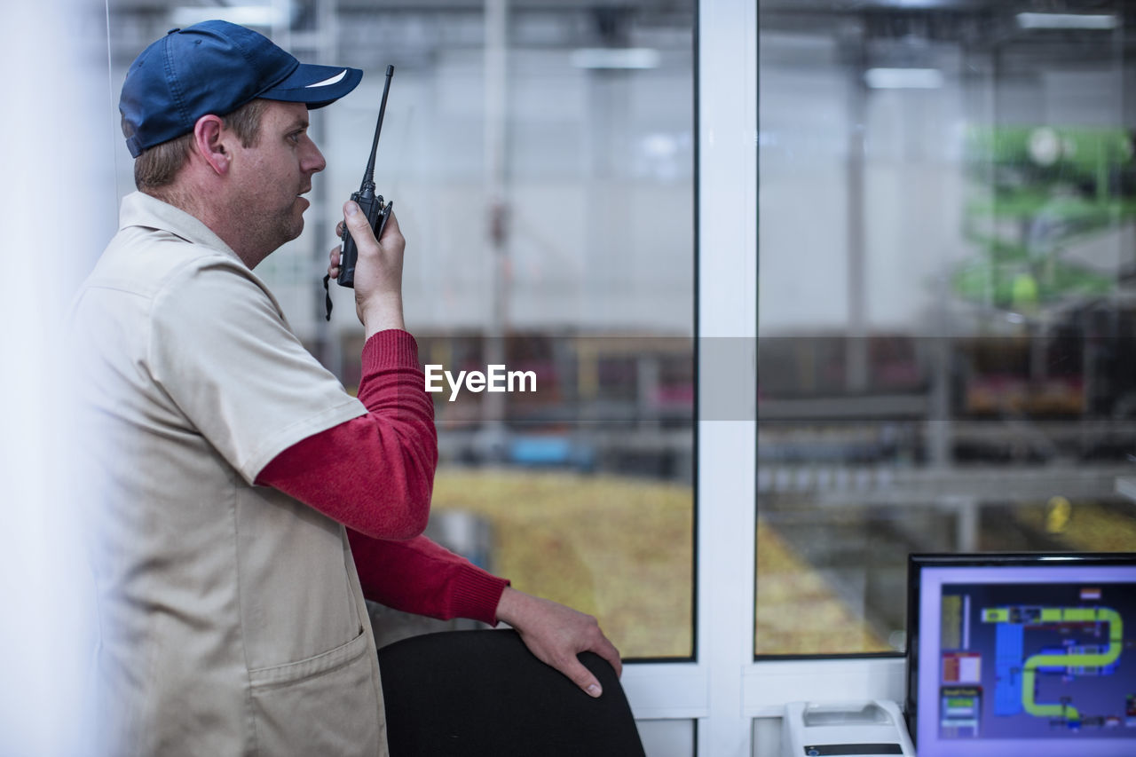 Worker with walkie-talkie instructing team