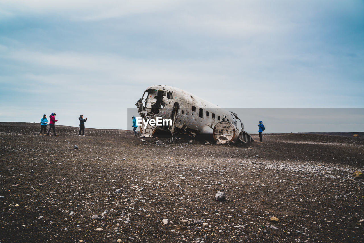 Abandoned airplane on land against sky