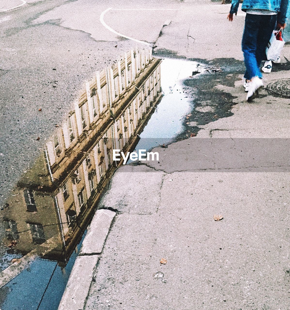 LOW SECTION OF MAN WALKING ON SIDEWALK