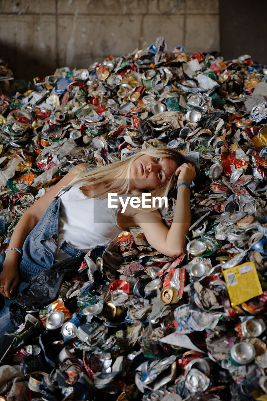 High angle view of woman lying down on garbage