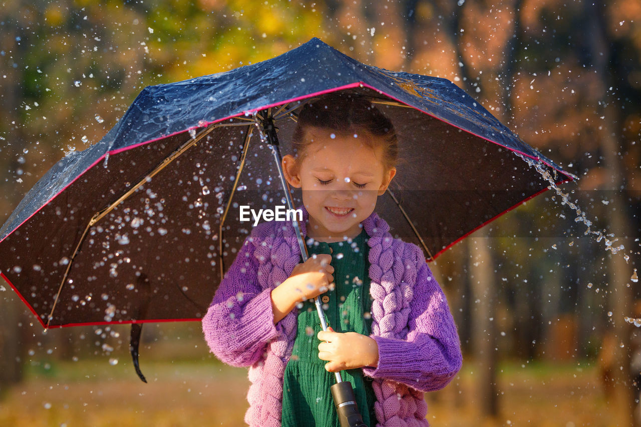 Cute girl holding umbrella