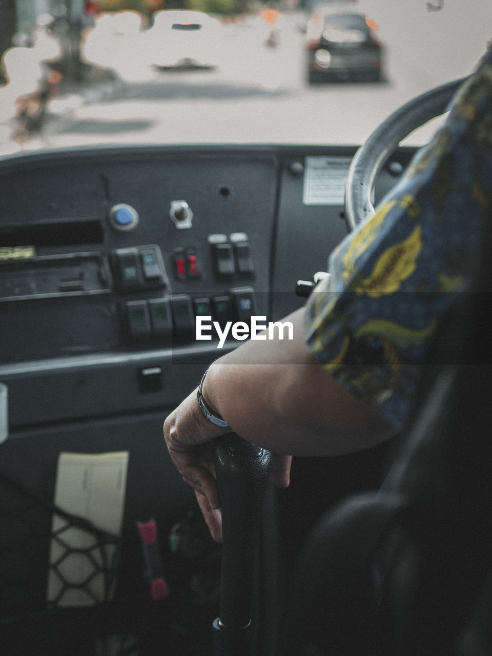 Cropped hand of man driving vehicle