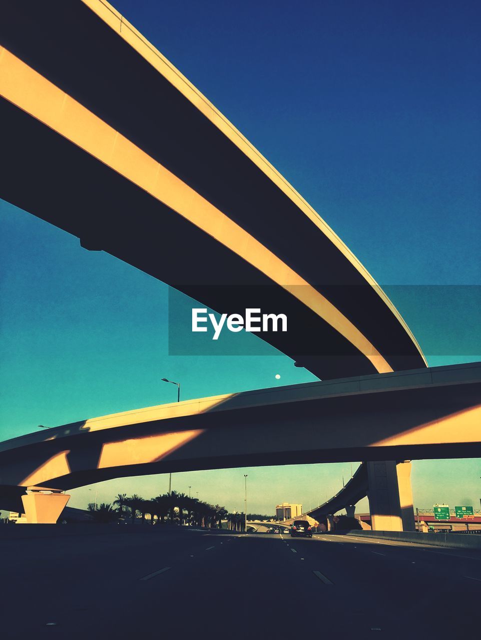 LOW ANGLE VIEW OF BRIDGE AGAINST BLUE SKY