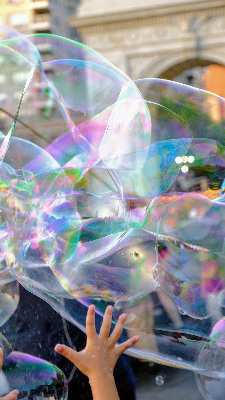 LOW ANGLE VIEW OF BUBBLE BUBBLES IN MID-AIR