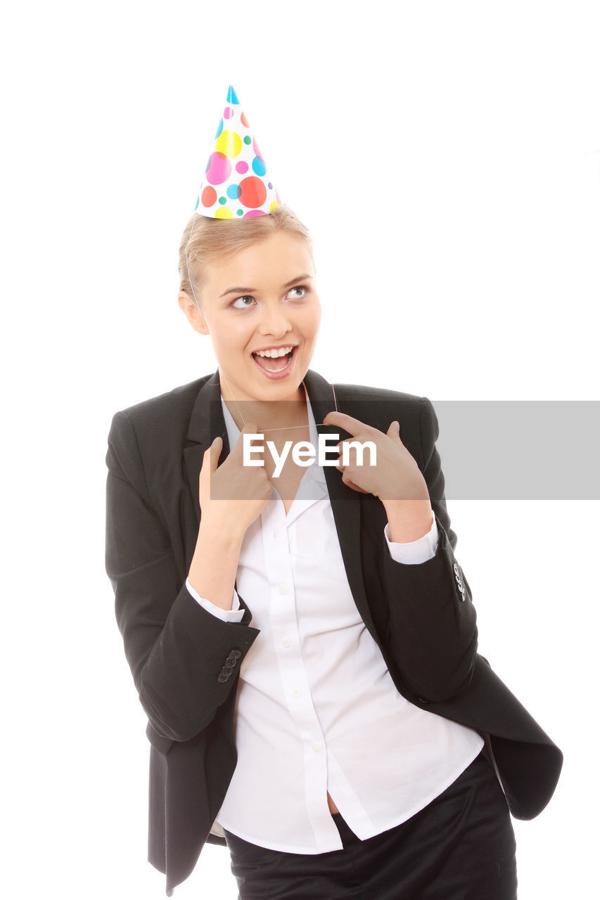 Businesswoman with party hat against white background
