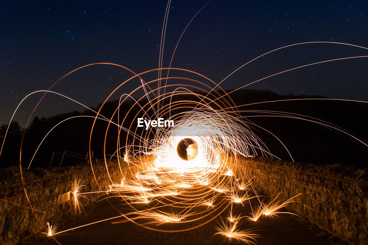 Fireworks against sky at night