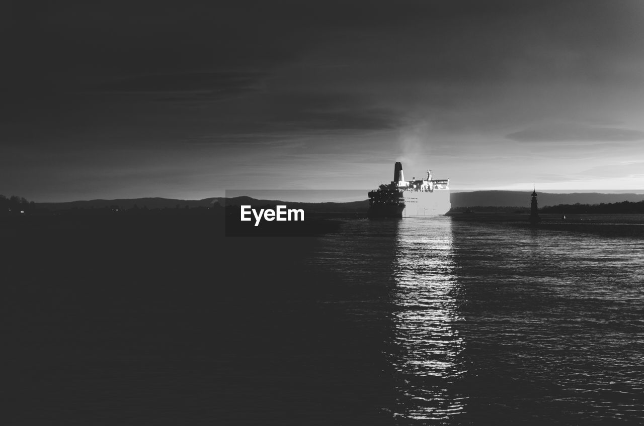 Silhouette ship in sea against sky, in black and white, in the norwegian capital of oslo