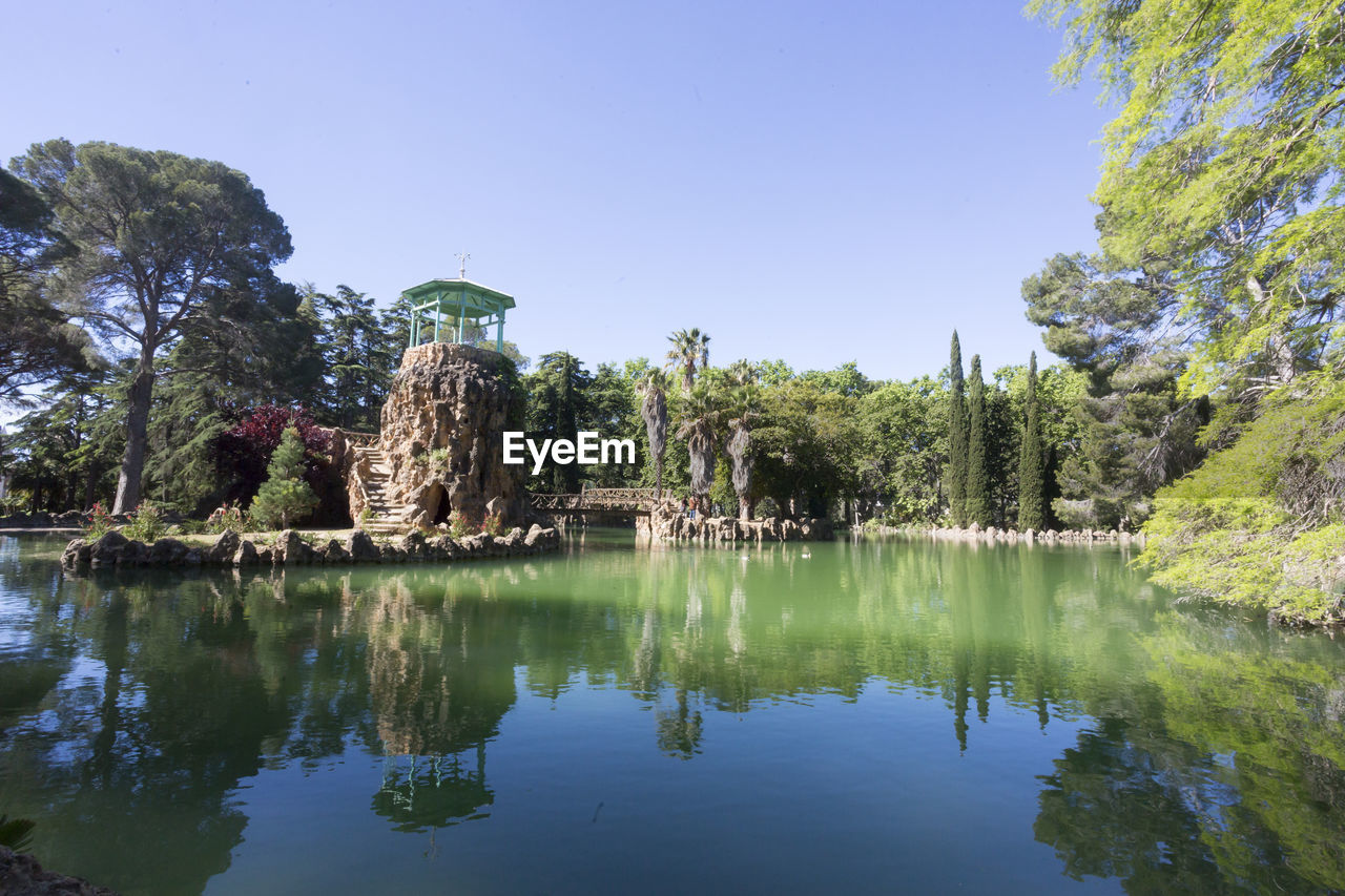 REFLECTION OF TREES IN LAKE