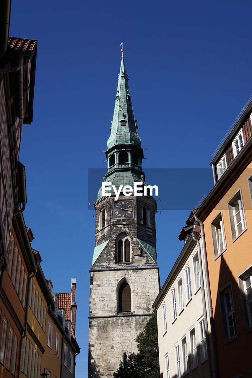 Low angle view of kreuzkirche against clear blue sky in city
