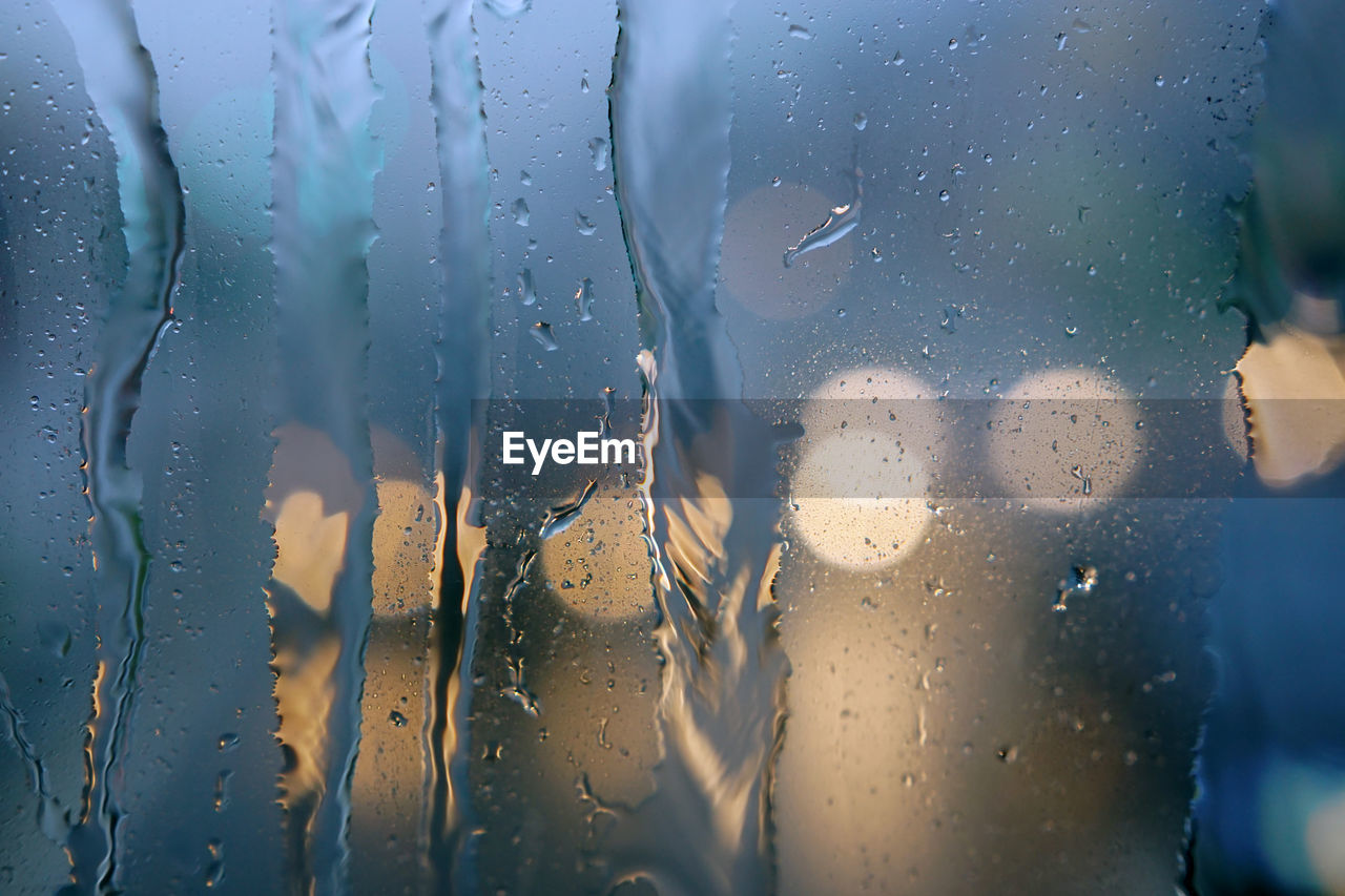Raindrops on the windshield of the car. focus selected. blur background