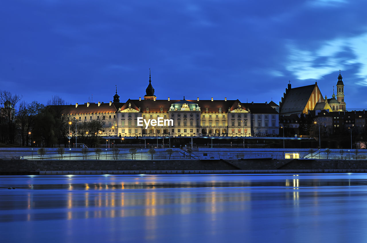 View of illuminated buildings against cloudy sky