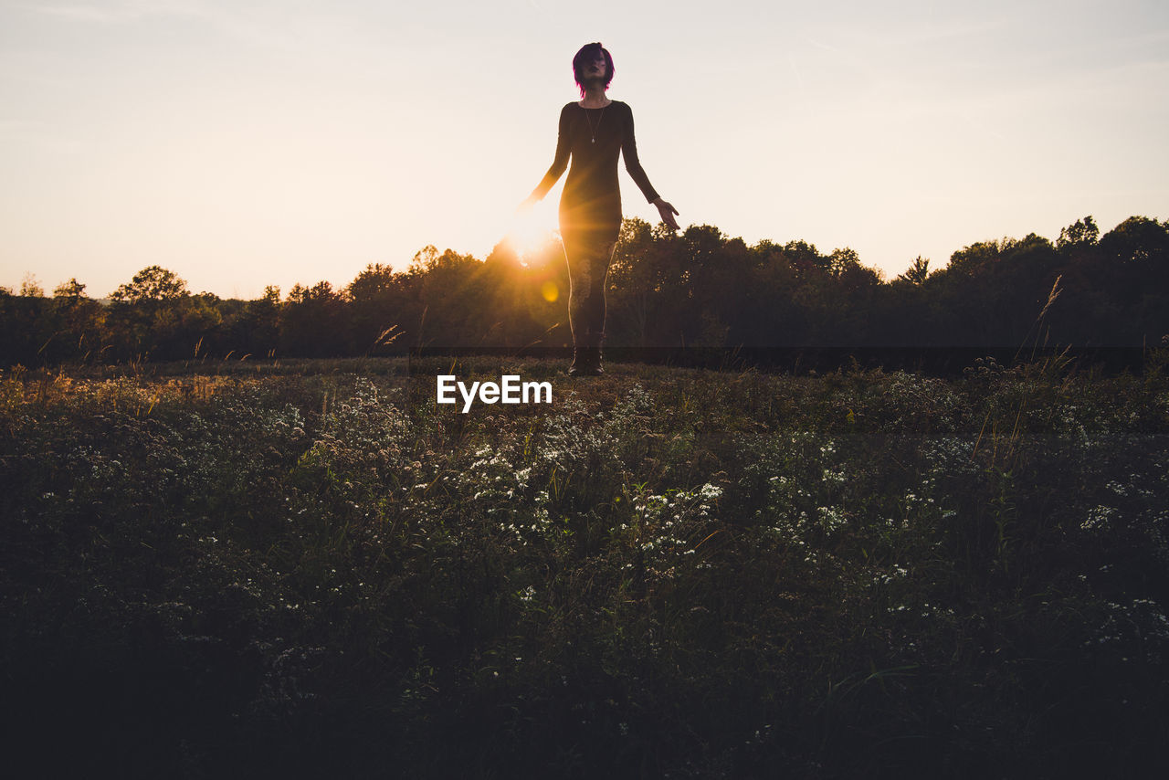 Silhouette of woman against sky during sunset