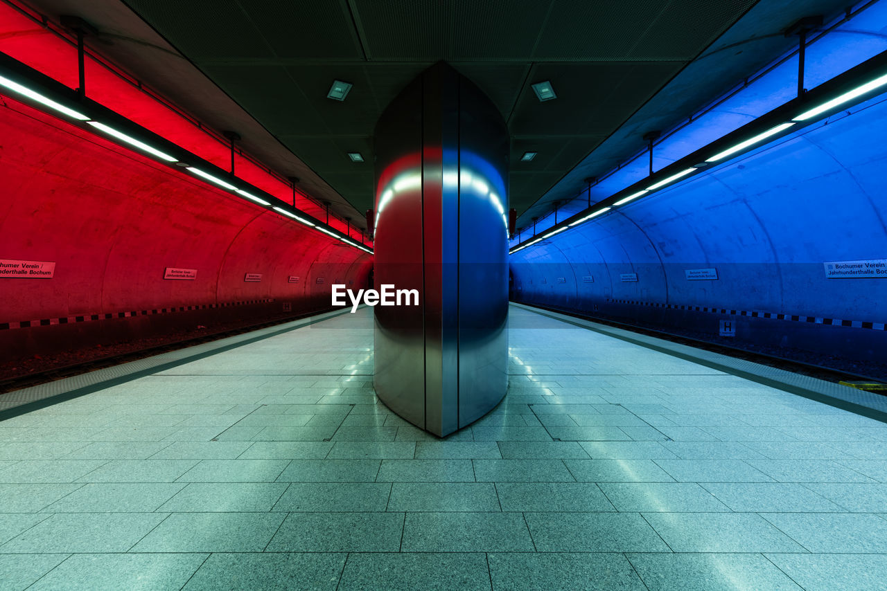 Diminishing perspective of illuminated railroad station platform