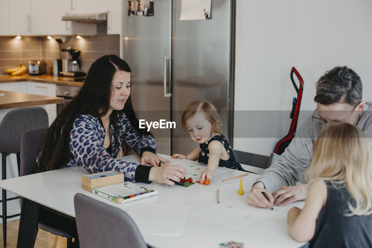 Parents with daughters drawing together