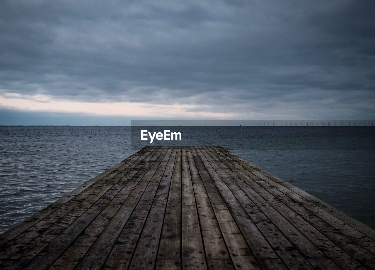 Pier over sea against sky