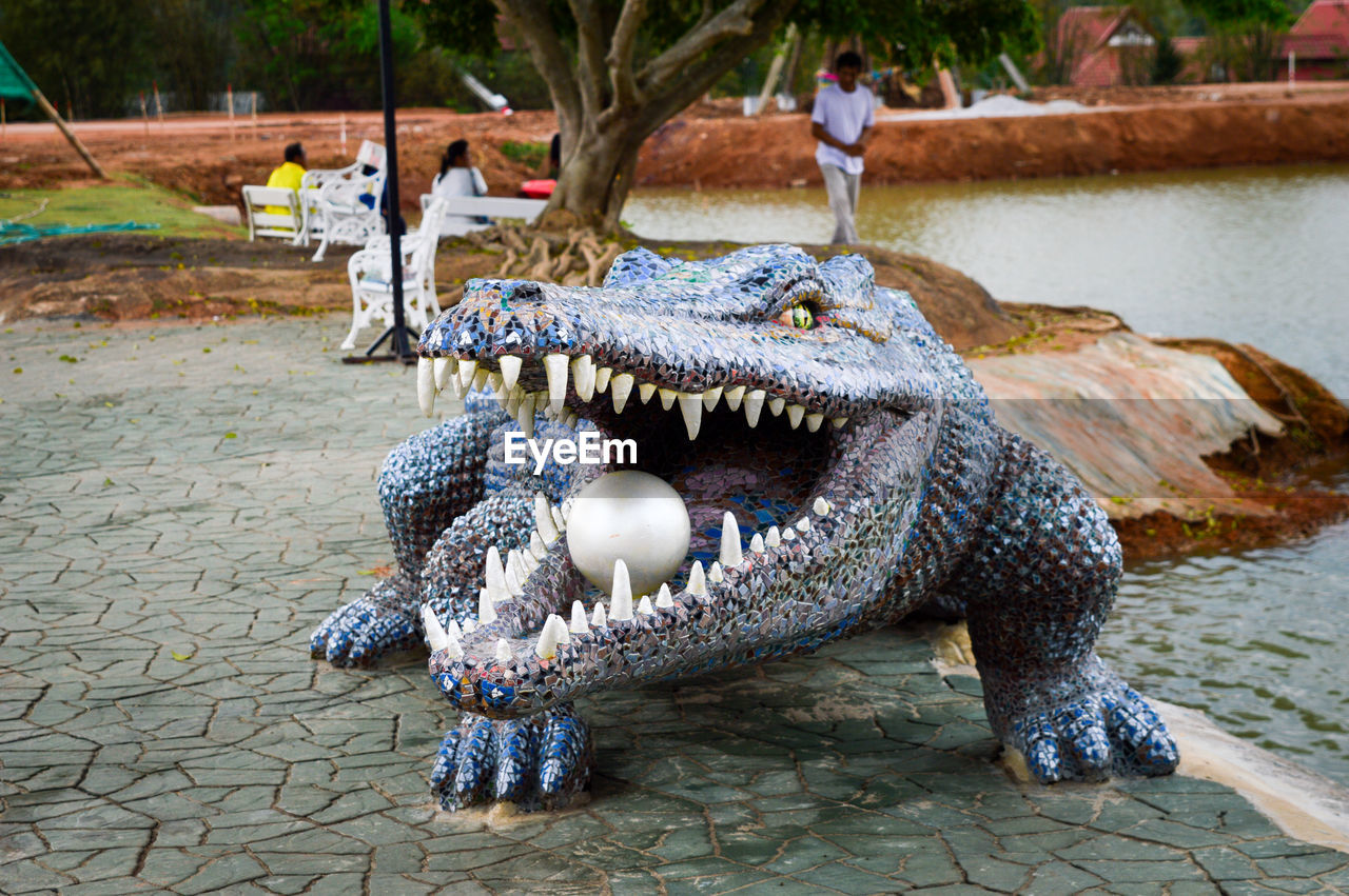 View of animal sculpture by water