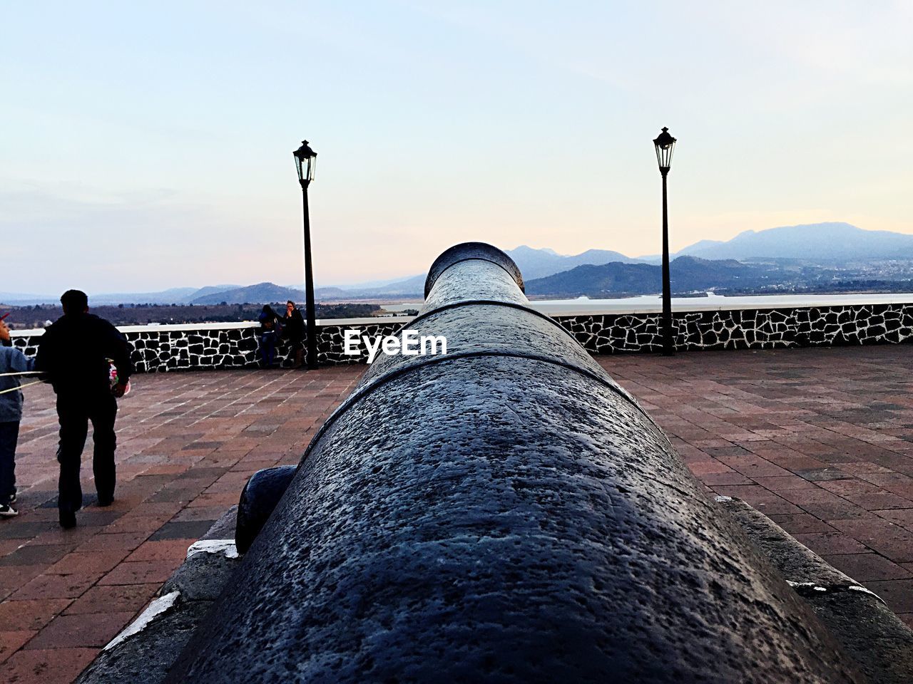 Cannon in front of river at sunset