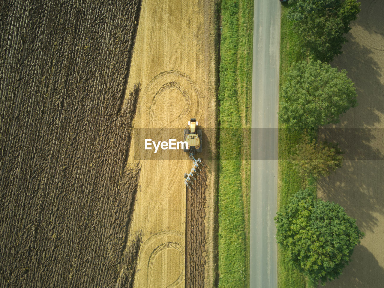 Drone aerial shots of a tractor ploughing a field at stone creek, sunk island, east yorkshire, uk.