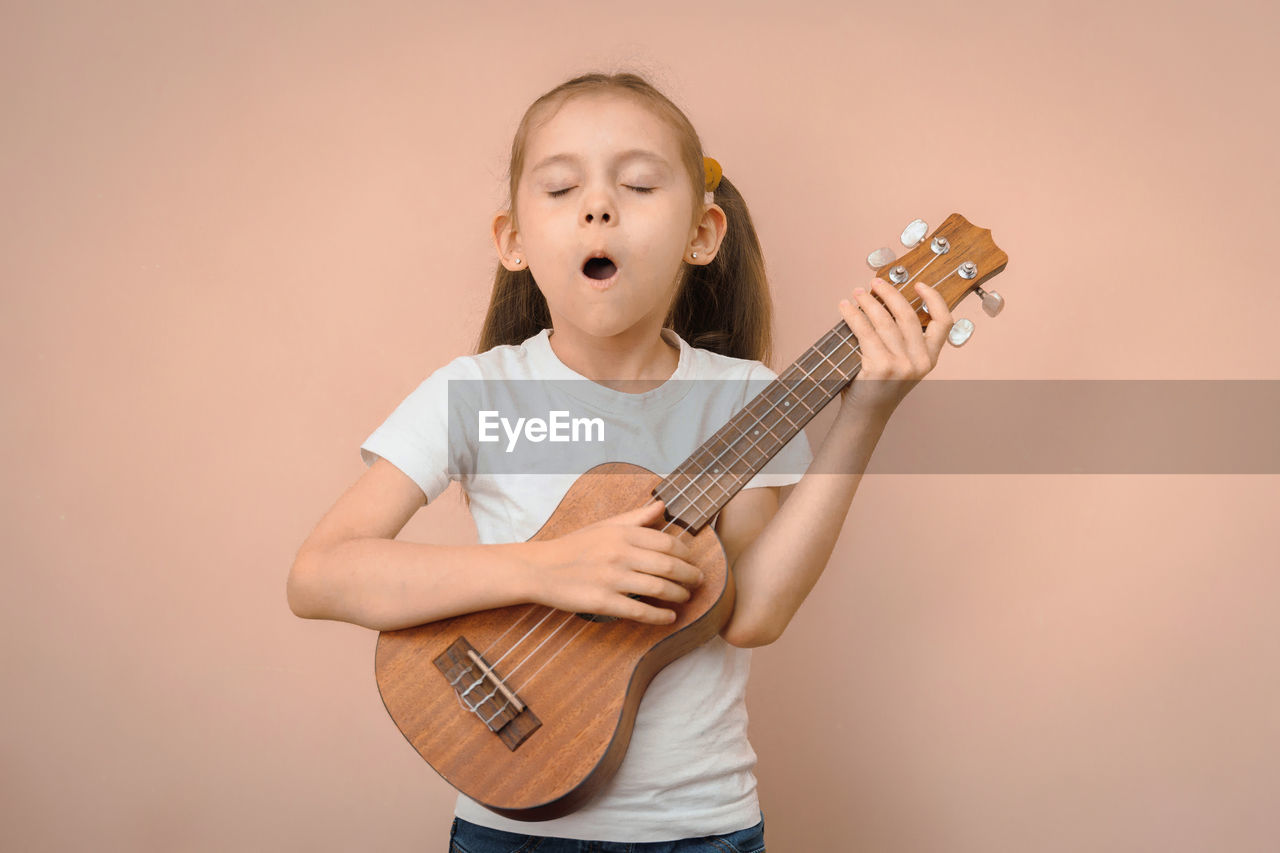 young woman playing guitar