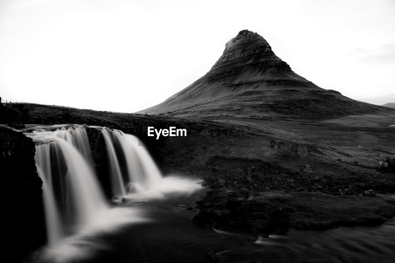 VIEW OF WATERFALL AGAINST SKY