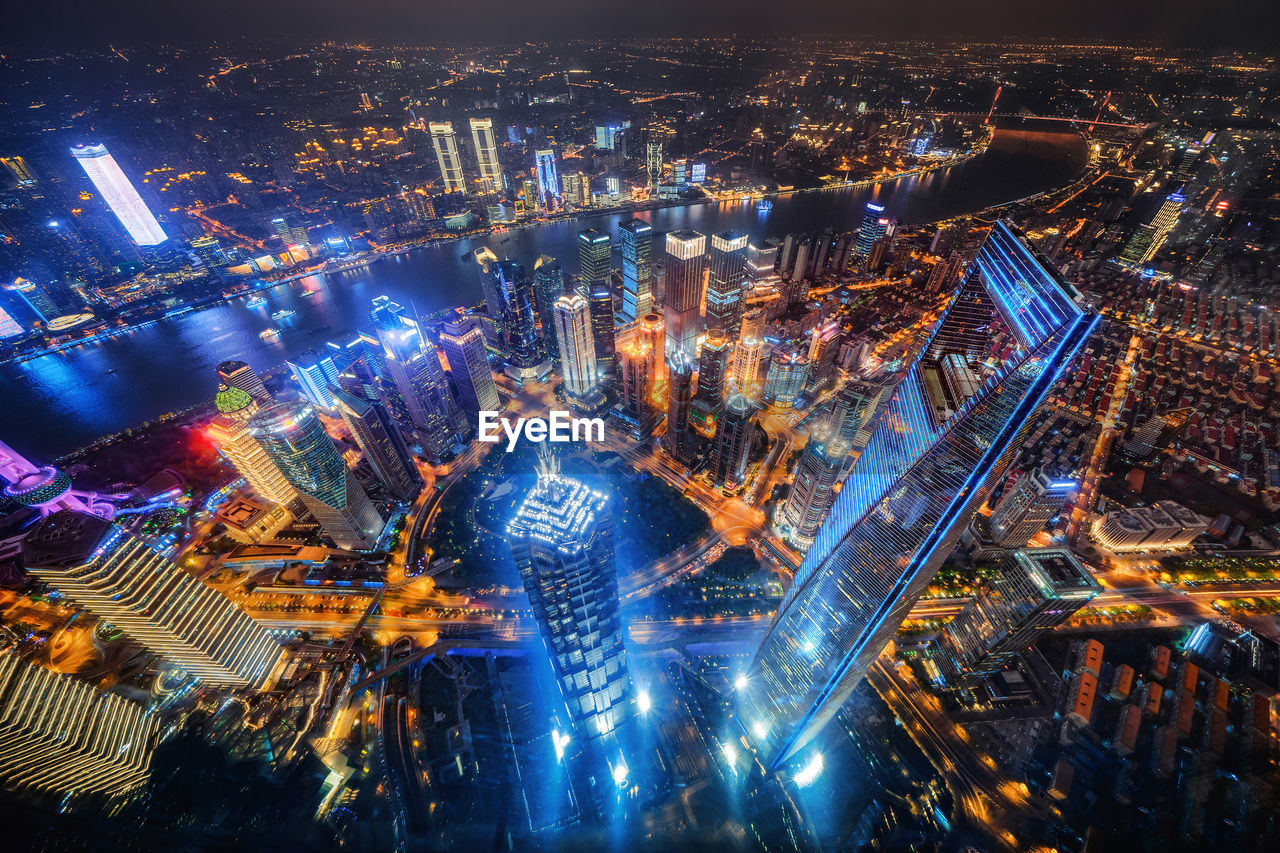 HIGH ANGLE VIEW OF ILLUMINATED CITY AT NIGHT