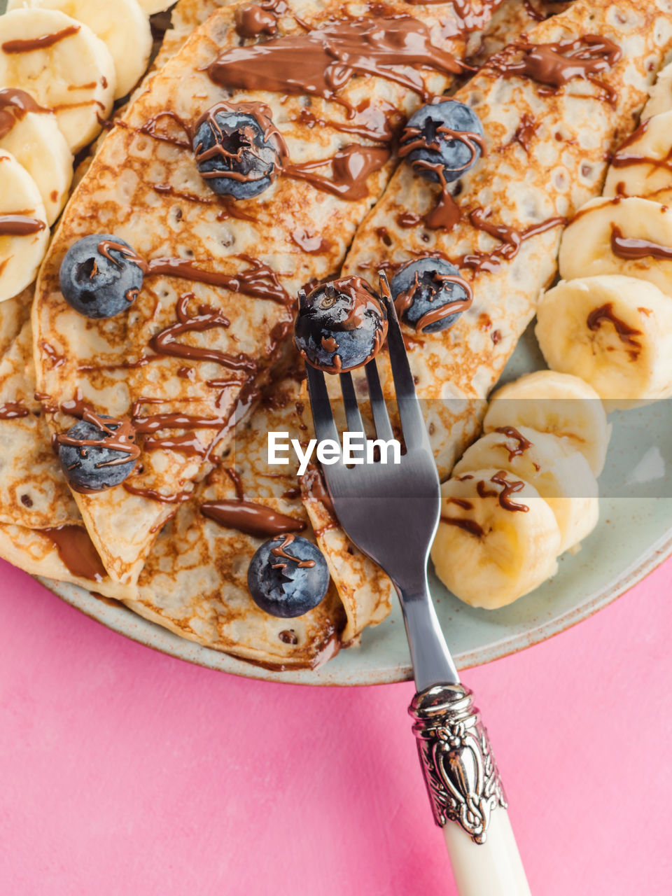 Delicious crepes filled with chocolate hazelnut spread and topped with banana and blueberries