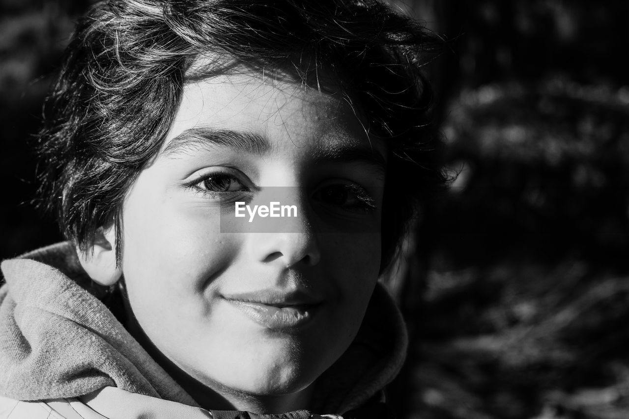 Close-up portrait of cute boy outdoors