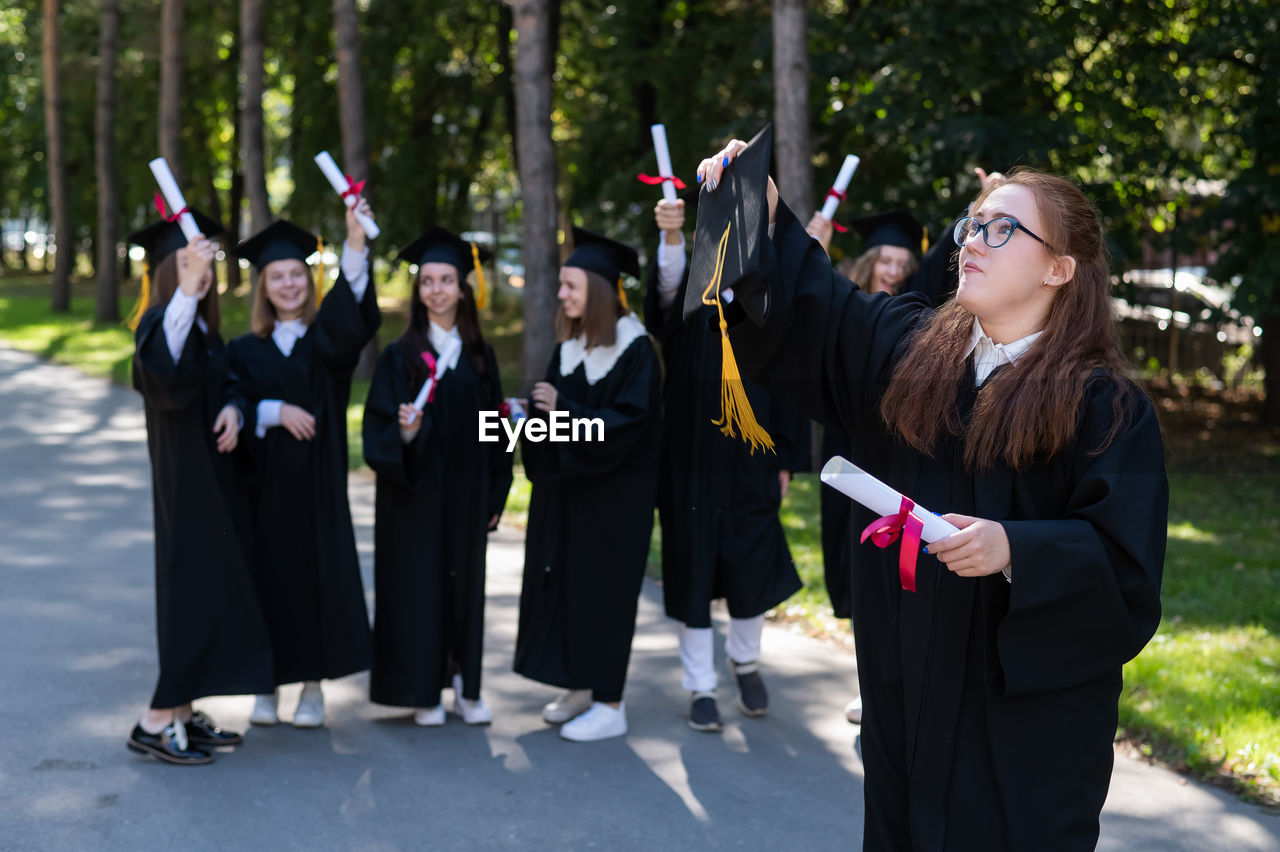 group of people in traditional clothing standing in park