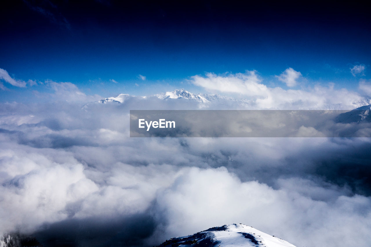 Scenic view of mountains against cloudy sky