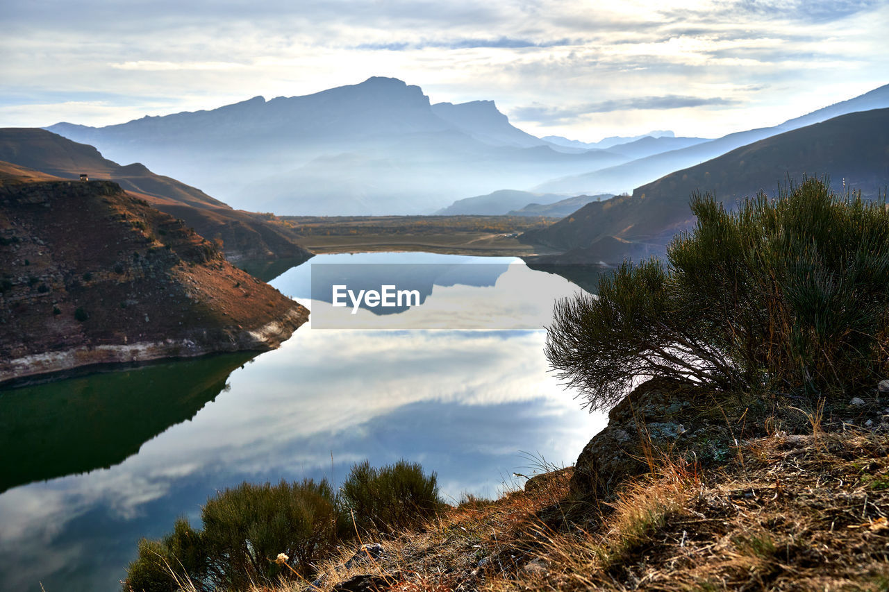Scenic view of lake and mountains against sky