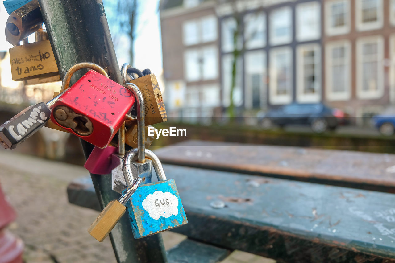 Close-up of love padlocks on railing against building