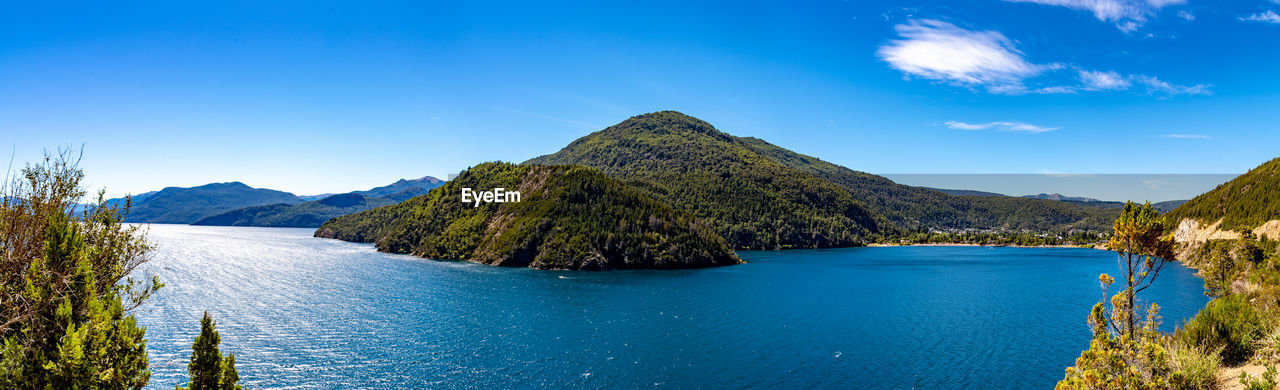 water, scenics - nature, mountain, sky, beauty in nature, land, nature, landscape, blue, environment, body of water, tree, travel destinations, plant, tranquility, tranquil scene, panoramic, travel, no people, lake, reflection, mountain range, forest, cloud, tourism, outdoors, idyllic, pine tree, beach, crater lake, non-urban scene, pinaceae, day, coniferous tree, clear sky, summer, vacation, island, trip, reservoir, holiday, mountain peak, sunny, coastline