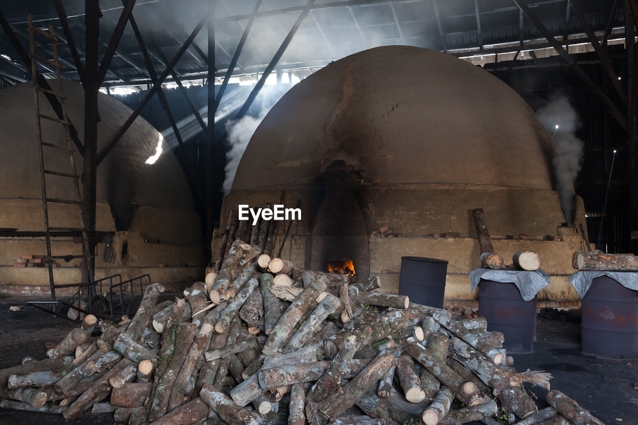 Smoke emitting from kiln by logs in industry