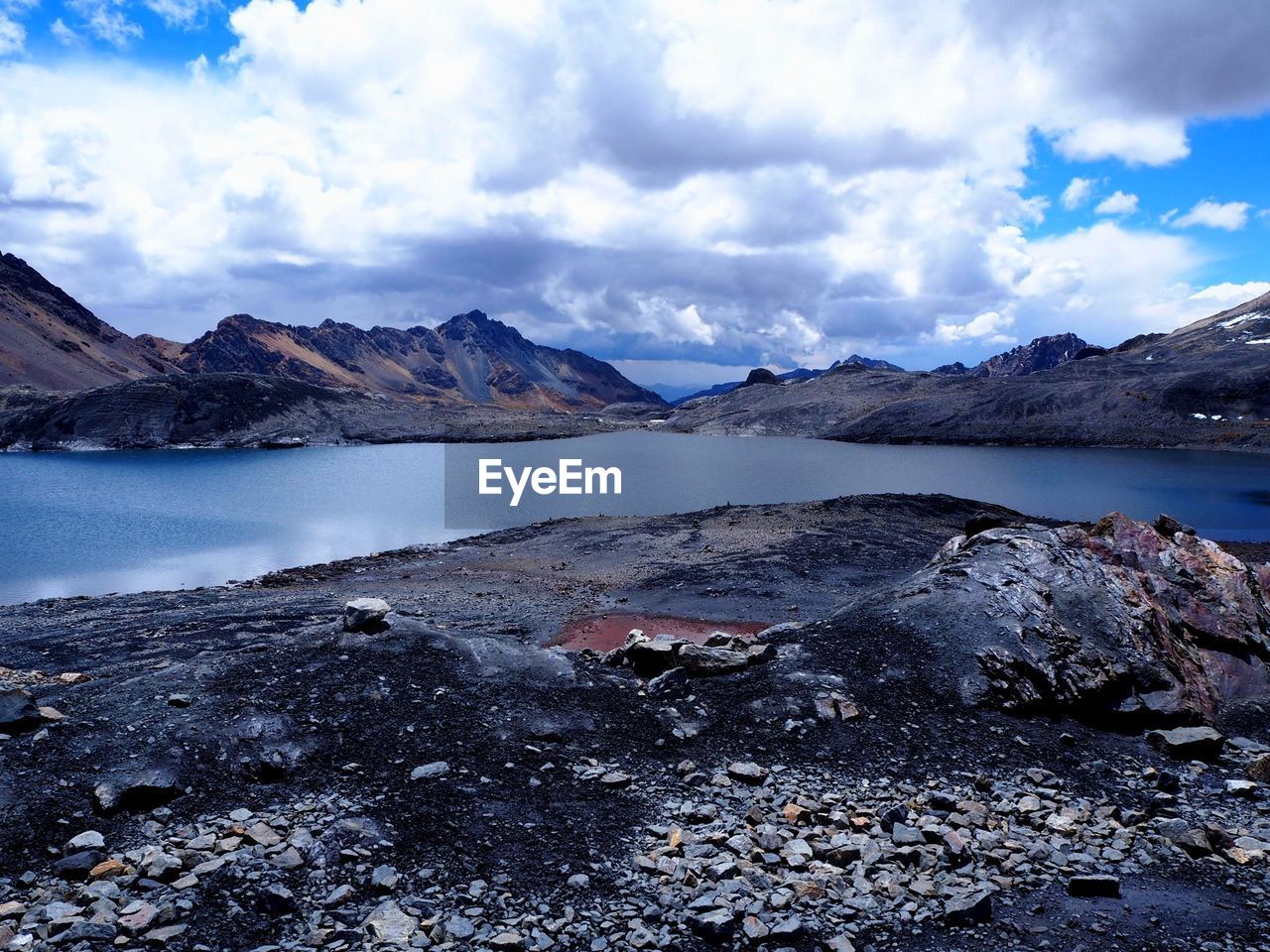 Scenic view of lake and mountains against sky