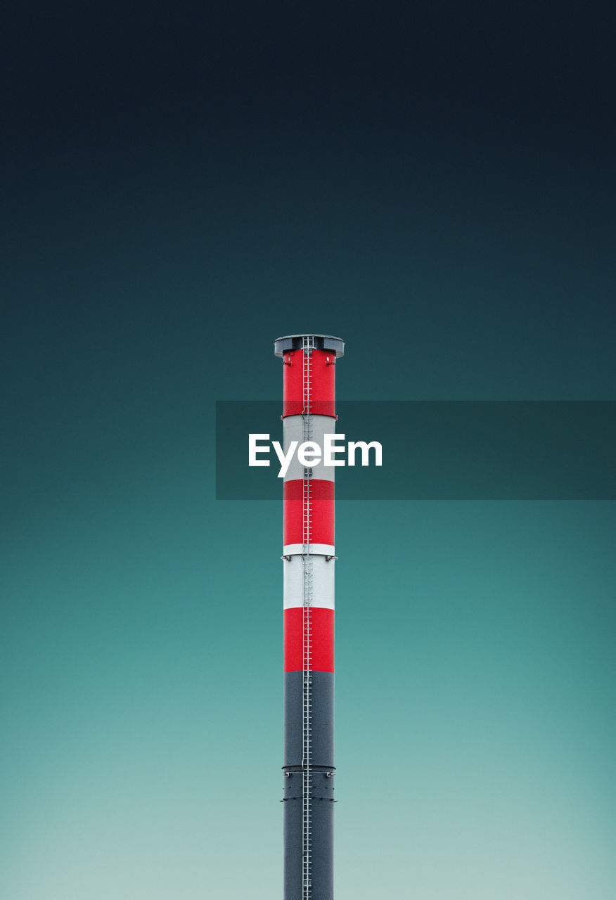 LOW ANGLE VIEW OF RED TOWER AGAINST CLEAR SKY
