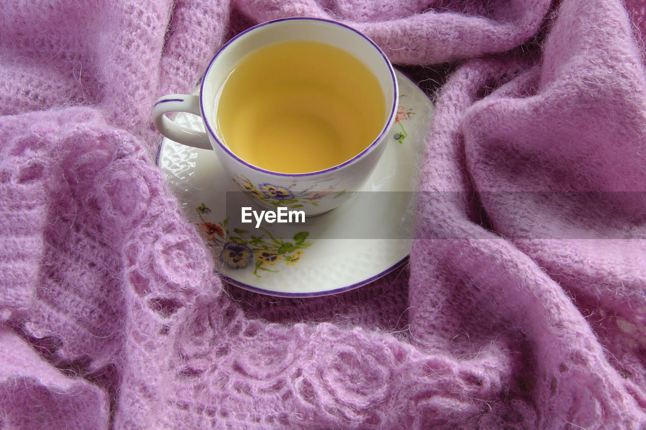 CLOSE-UP OF TEA CUP ON PINK