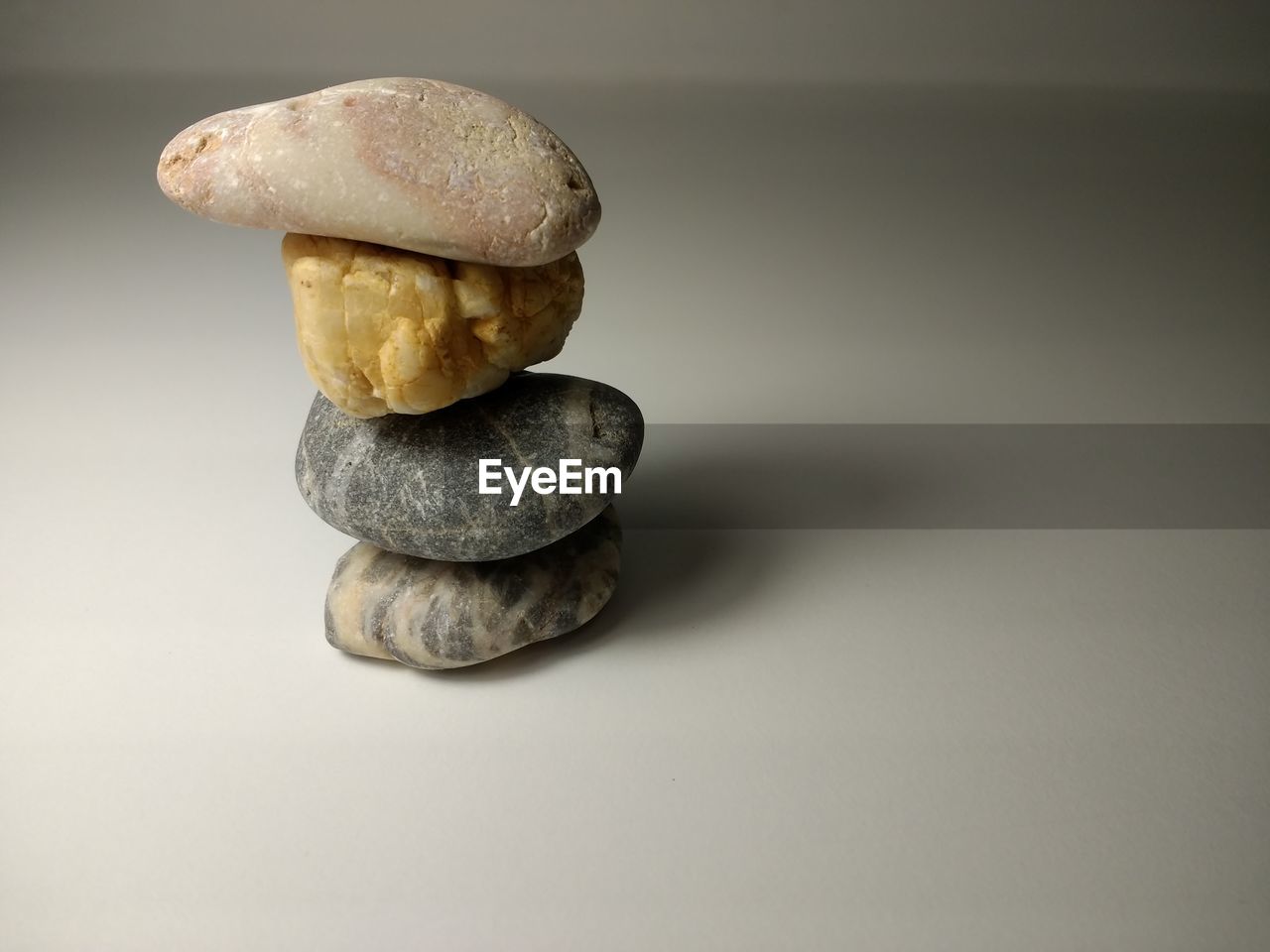 Close-up of stacked pebbles on table