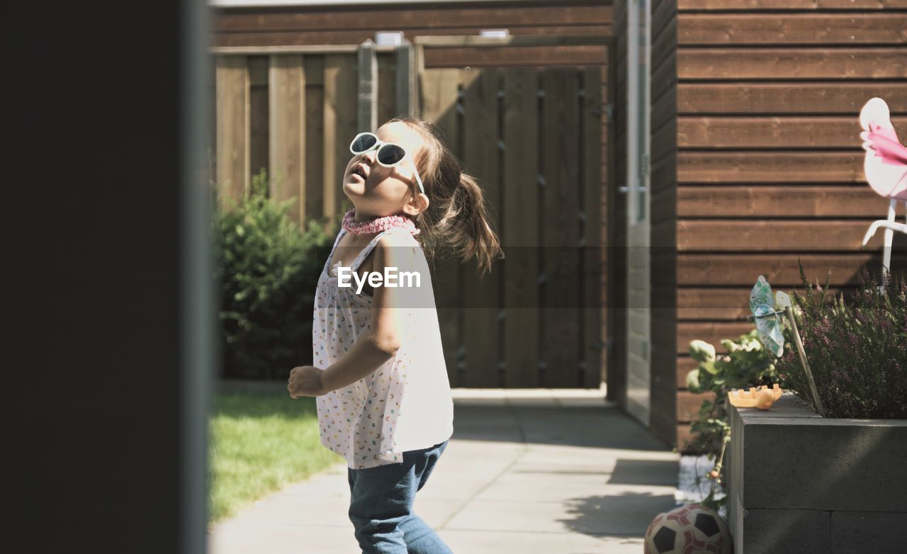 Girl wearing sunglasses standing outdoors