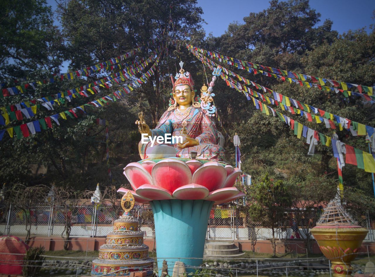 STATUE OF TEMPLE AGAINST TREES
